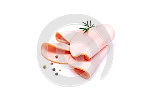 Rolled ham slices isolated on white background with herbs and spices