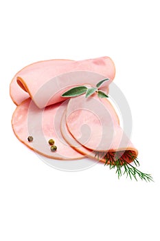 Rolled ham slices isolated on white background with herbs and spices