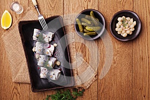 Rolled herring in vinegar, served with onions and pickles