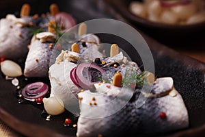 Rolled herring in vinegar, served with onions and pickles