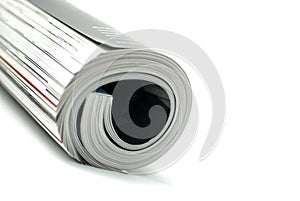 Rolled magazine isolated on white background.