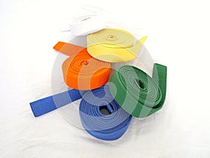 Rolled martial arts belt blue green orange yellow white