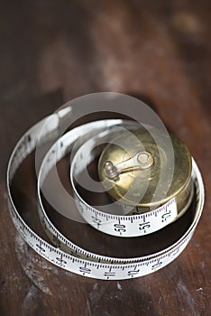 Rolled Measuring Tape on Hardwood Surface