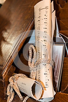 Rolled Music Sheet with aged photo over wooden drawer