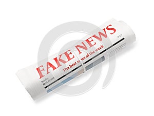 Rolled newspaper with headline FAKE NEWS on white background