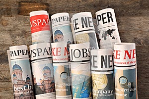 Rolled newspapers on wooden background