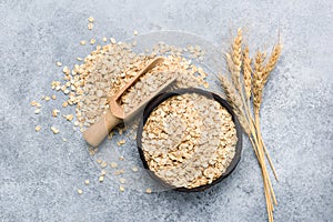 Rolled oats or oat flakes in bowl top view photo