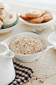 rolled oats, plant milk and cookies on a table