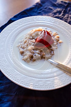 Rolled oats porridge with milk and jelly