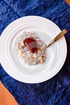 Rolled oats porridge with milk and jelly