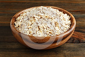 Rolled oats in a wooden bowl