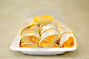 Rolled pancakes on plate