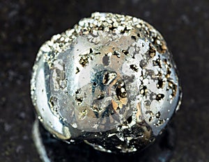 rolled Pyrite (fool\'s gold) rock on black