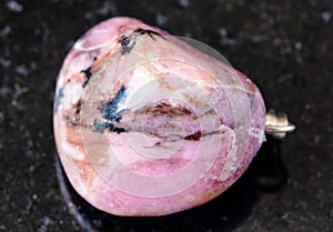 rolled Rhodonite rock on black