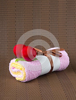 Rolled towel at brown background