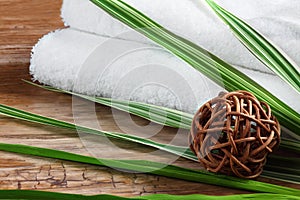 Rolled towels with pedig sphere and bamboo grass