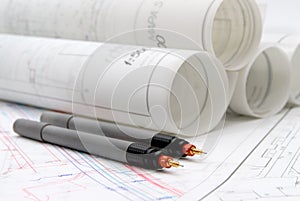 Rolled-up architectural plans and drawing tools