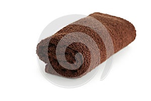 Rolled up brown towel isolated on a white