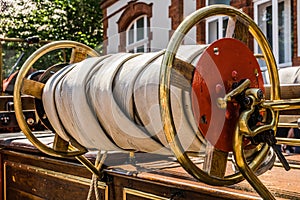 Rolled up hose of a historical fire engine of the fire brigade at an oldtimer exhibition