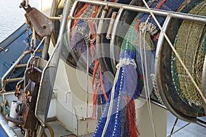 Rolled up industrial ishing nets on a winch aboard a fishing boat