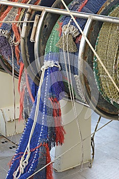 Rolled up industrial ishing nets on a winch aboard a fishing boat