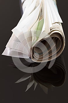 Rolled up newspaper on black 2