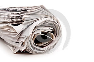 Rolled up newspaper on white