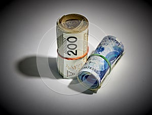 Rolled up polish money PLN - two hundred polish zloty bills isolated on a white background