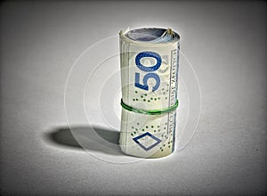 Rolled up polish money PLN - two hundred polish zloty bills isolated on a white background