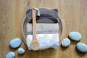 Rolled up towels and body dry brush for male exfoliation