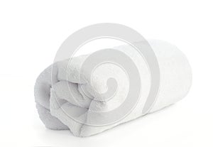 Rolled up white beach towel