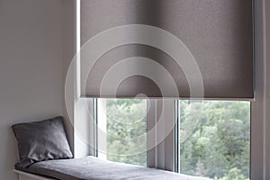 Roller blind close up on large window in the interior