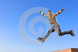 Roller boy jumping from parapet