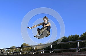 Roller boy jumping from parapet