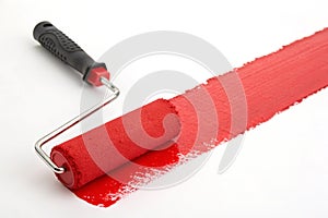 Roller brush with red paint stroke photo