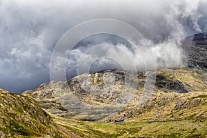 A roller of clouds rolled over the mountains of Snowdonia in Wales in the sunshine.