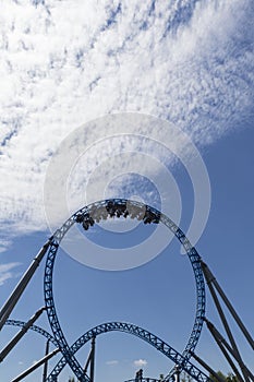 Roller coaster loop and blue sky