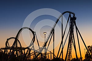 Roller coaster silhouette at sunset