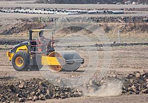 Roller-compactor or Earth or Ground or Road Leveler and Roller working in the Field