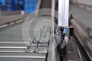 Roller conveyor with laser distance sensor.