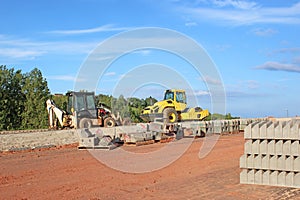 Roller and digger on a construction site