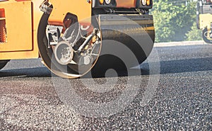 the roller flattens the asphalt tar, paving the new asphalt