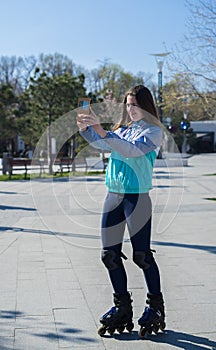 Roller Girl standing and shooting selfie on smartphone