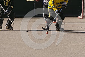 a roller hockey player breaking out with the puck