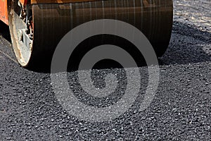 Roller machine working on the asphalt road construction.