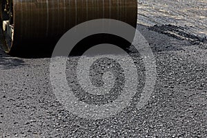 Roller machine working on the asphalt road construction.