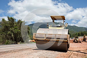 Roller rolling fresh hot asphalt on the new road. Road construction