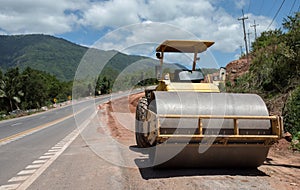 Roller rolling fresh hot asphalt on the new road. Road construction