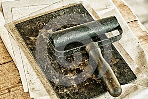 Roller for rolling ink vintage print books. Tools of ancient printing. Roller in an old workshop on typography