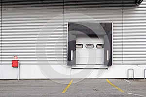 Roller shutter door and concrete floor inside factory building for industrial background.